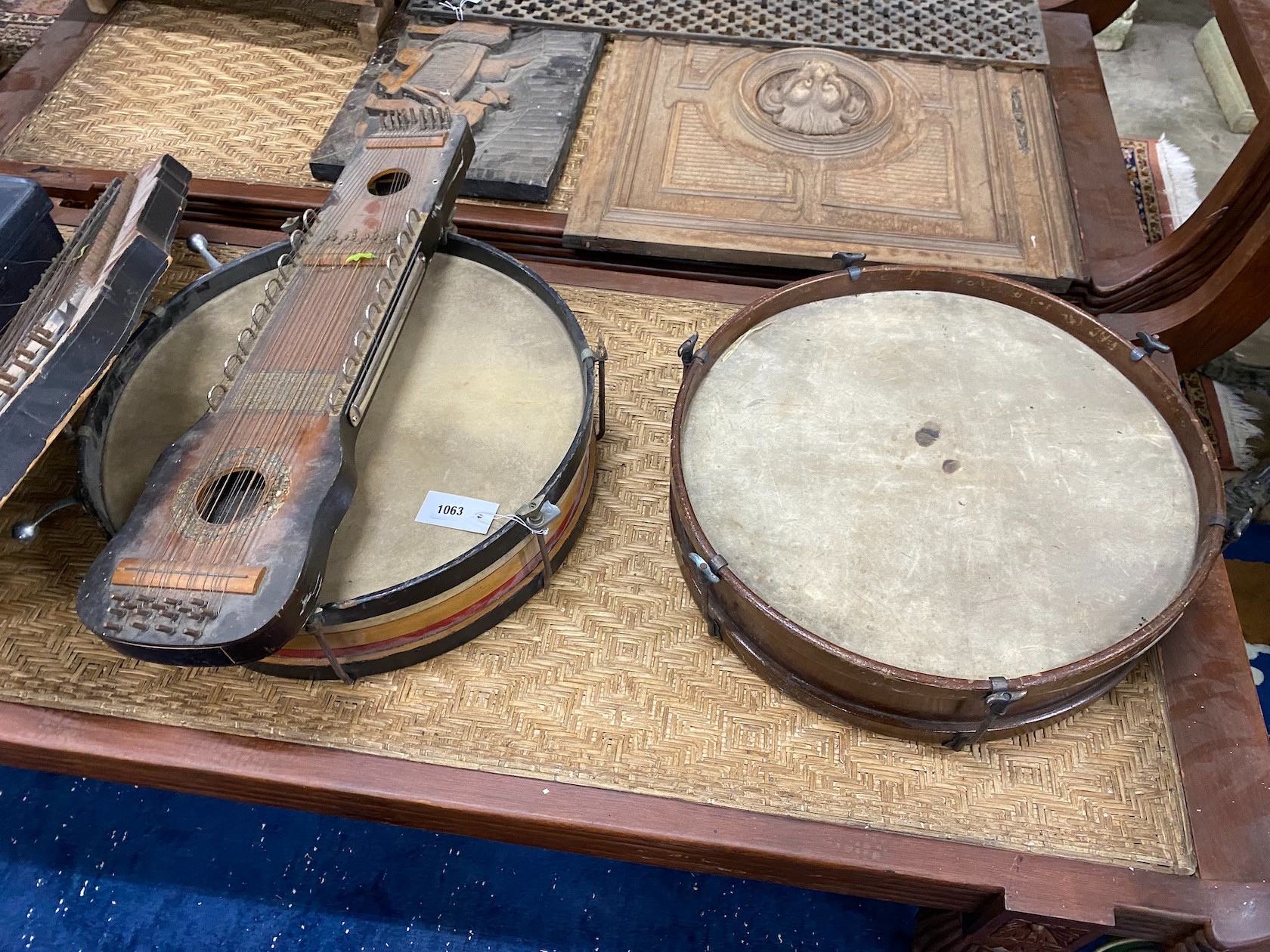 A group of assorted musical instruments comprising two large tambourines, two zithers and a Zenith trumpet